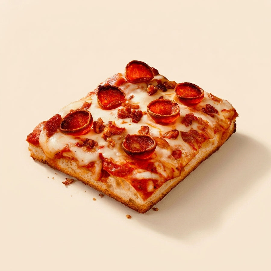 A square slice of pepperoni pizza with melted cheese and crispy bacon bits, photographed on a clean, solid cream background.