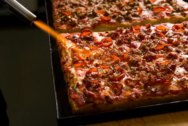 Freshly baked rectangular Slices Roman-style pizza